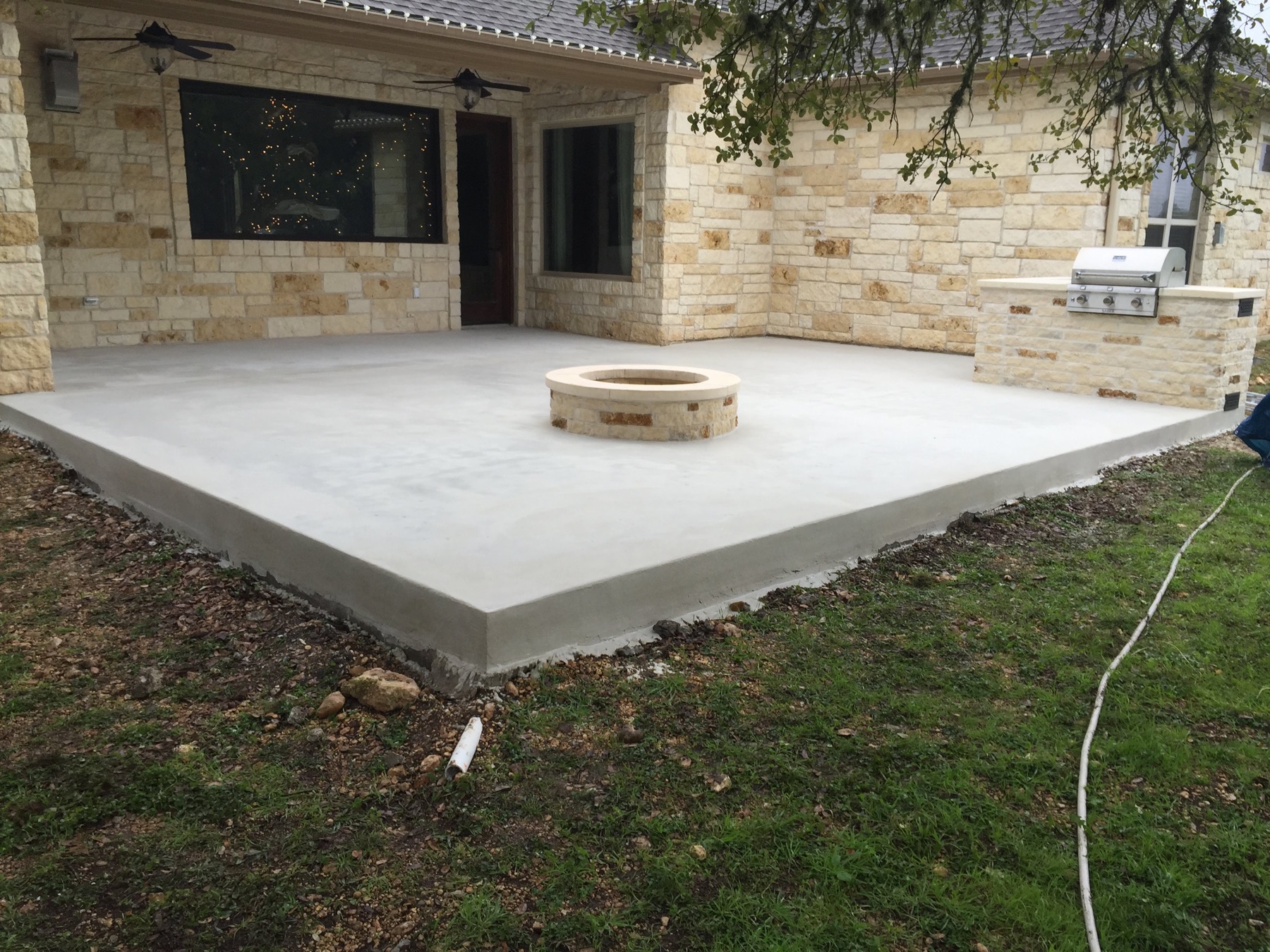 Wide view of the PetraBroom patio and fire pit after the first coat