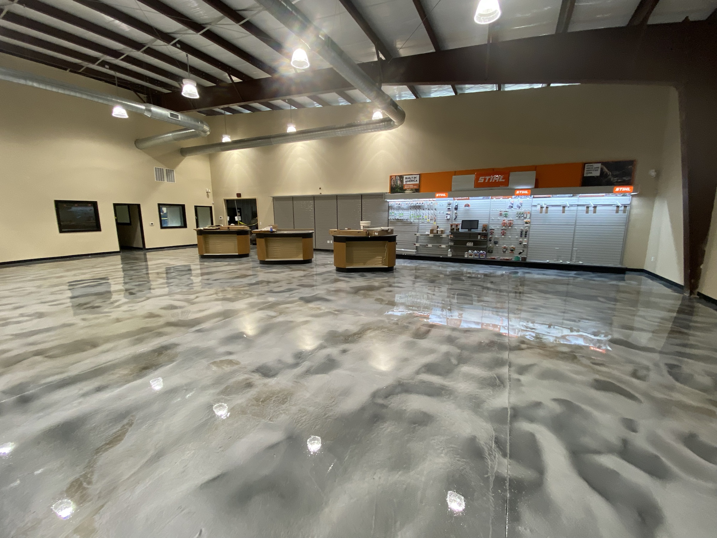 Finished silver and charcoal Rezena Metallic floor in a commercial showroom